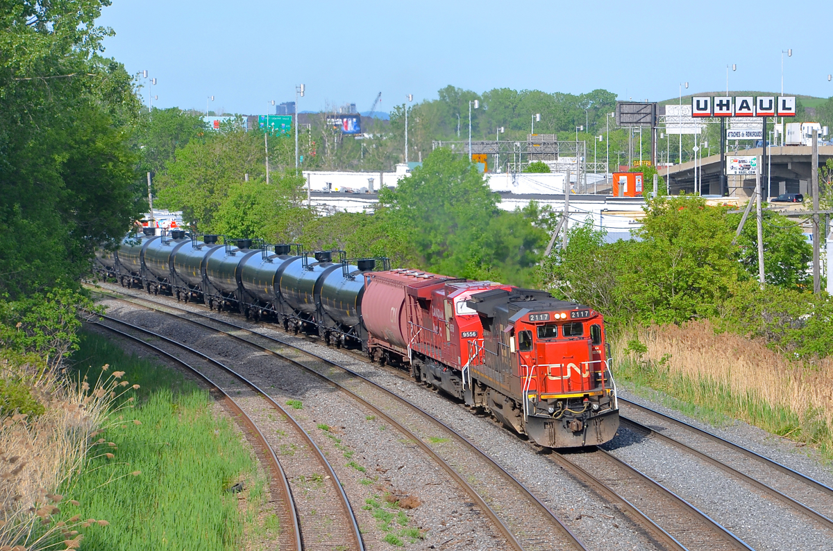 CN 711 is departing Turcot West after a crew change with CN 2117 and CP 9556 in May 2014. CN 711 was an empty oil train running from Joffre Yard near Quebec City to interchange with BNSF near Chicago. It has not run since the spring of 2015.