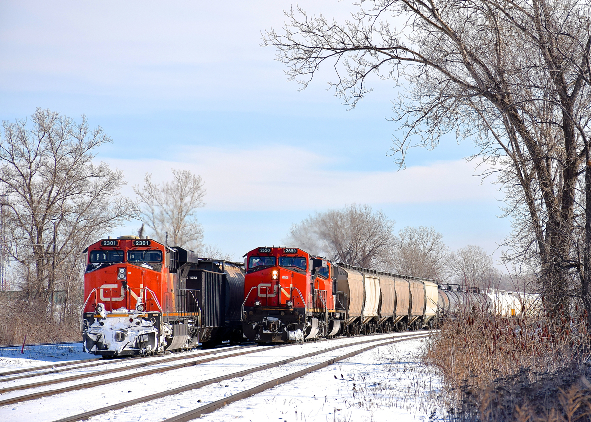 CN 369 at left and CN X371 at right are both stopped at Dorval, waiting for permission to head west. They are delayed due to an incident involving VIA 61 in Coteau which delayed all VIA Rail and CN freight trains this morning. A few minutes after I took this photo CN 369 would depart, with CN X371 following about a half hour later.