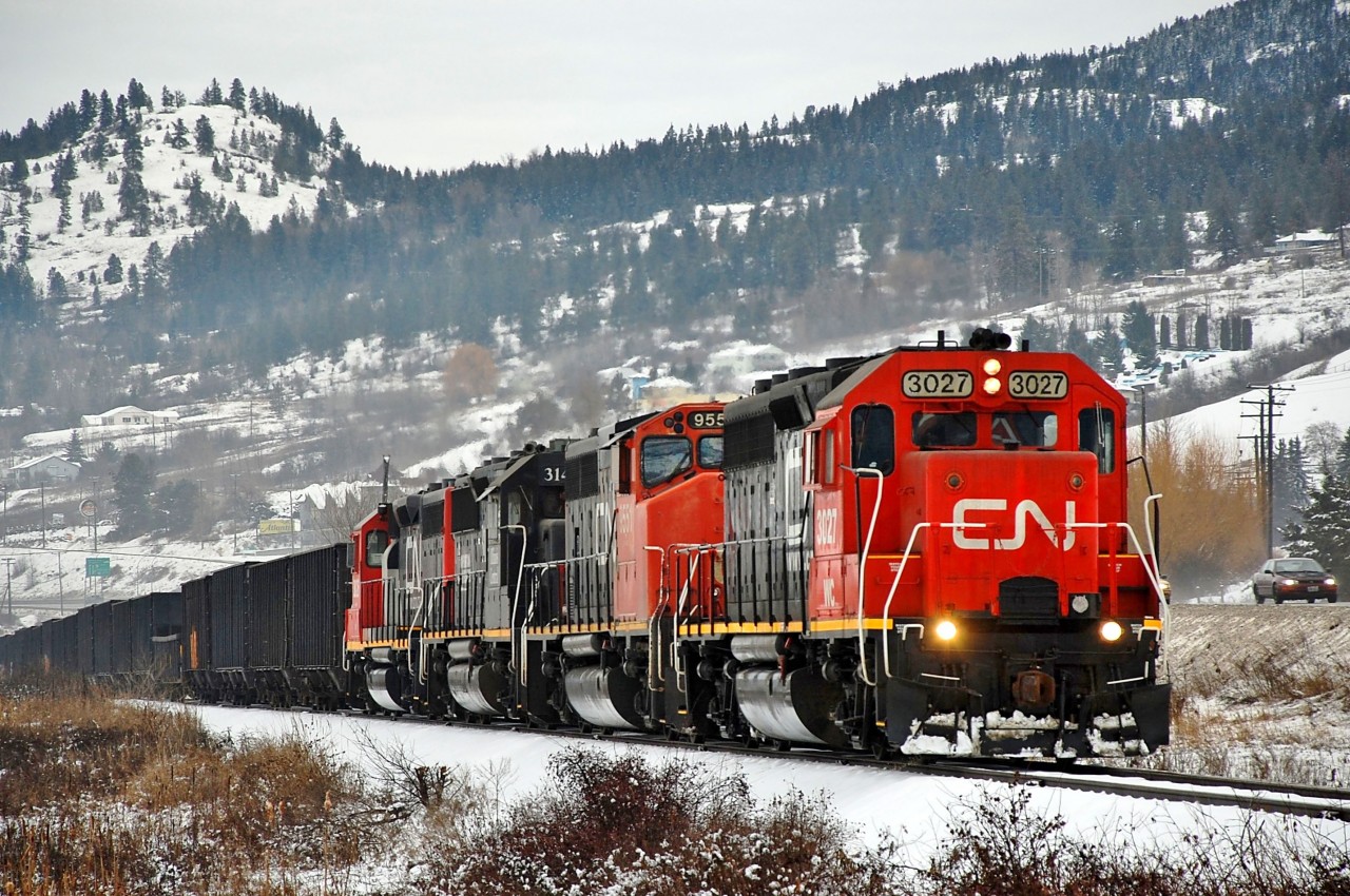 CN returned to operation of the Okanagan sub in Dec.2013. Initially and before upgrading of the track only four axle locos were used, and this shot shows four such units running alongside Hwy97 and approaching Vernon from the north. The units seen are WC 3026,3027, CN 9551 & IC 3140.