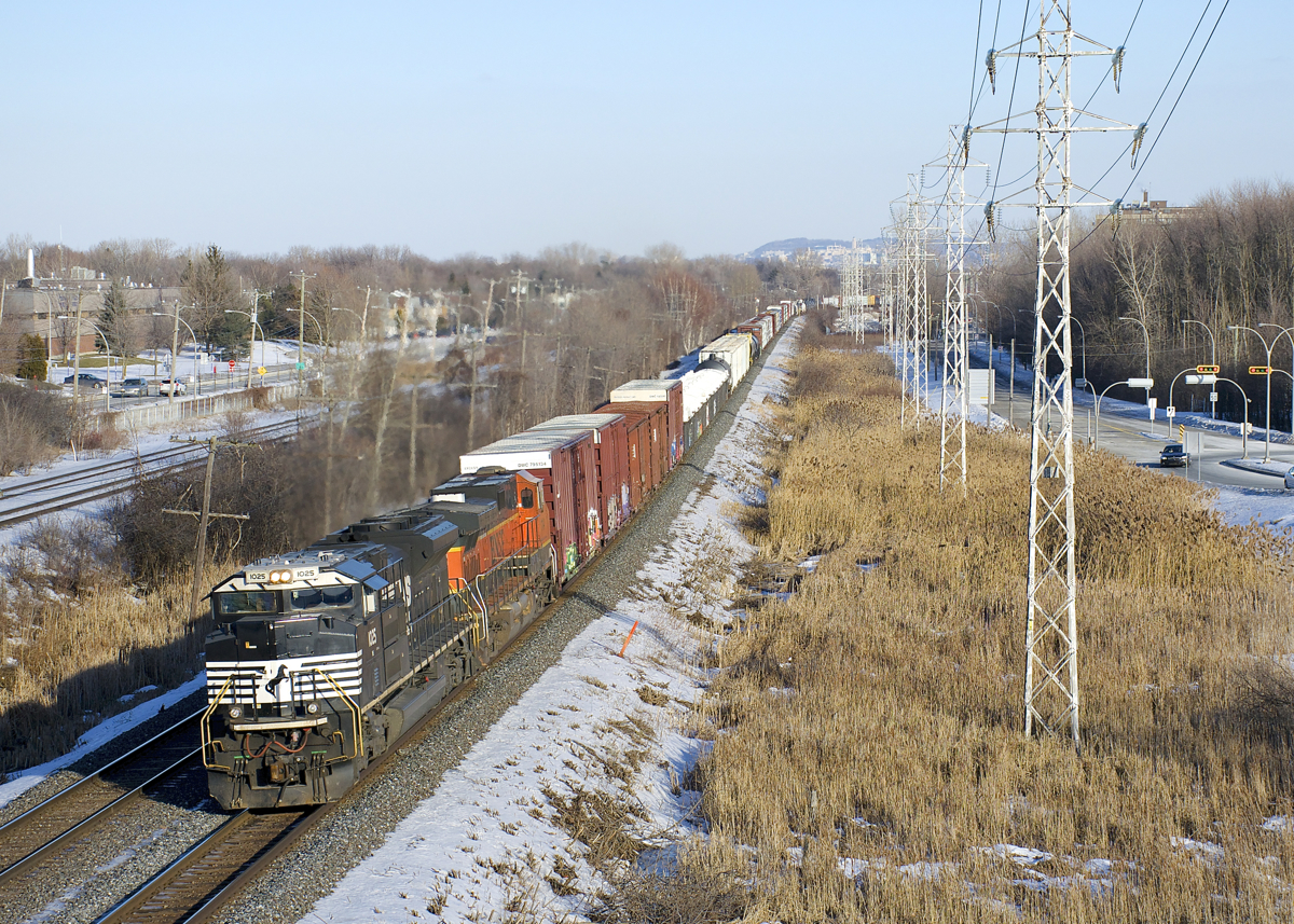 CN 327 is a train that runs through to CSX tracks and that almost always has CSX power. Today was an exception with NS 1025 and BNSF 1114 providing the power on a sunny winter afternoon as the train is westbound on CN's Kingston Sub.