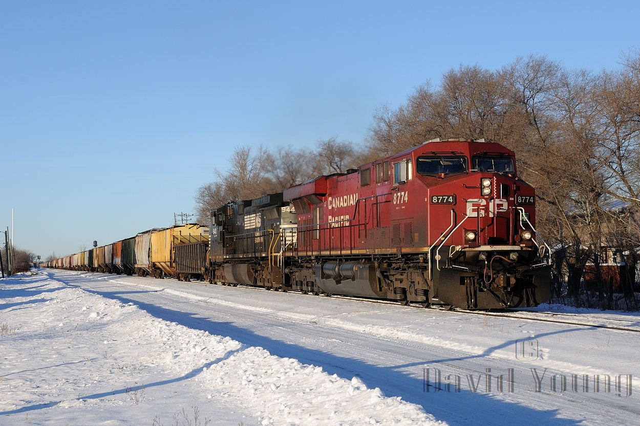 CP ES44AC 8774 and NS C40-9W 9440 -with an American crew aboard- start train 298 on its trip south, rumbling through St. Boniface with a crew change destined at Thief River Falls, Minnesota. This practice has since been stopped arbitrarily due to collective bargaining differences. Canadian crews out of Winnipeg once again run down to Emerson to crew change with Thief River crews.