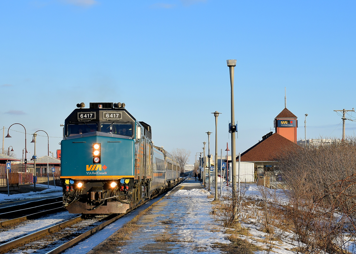VIA 635 departs Dorval Station after boarding passengers on a sunny afternoon.