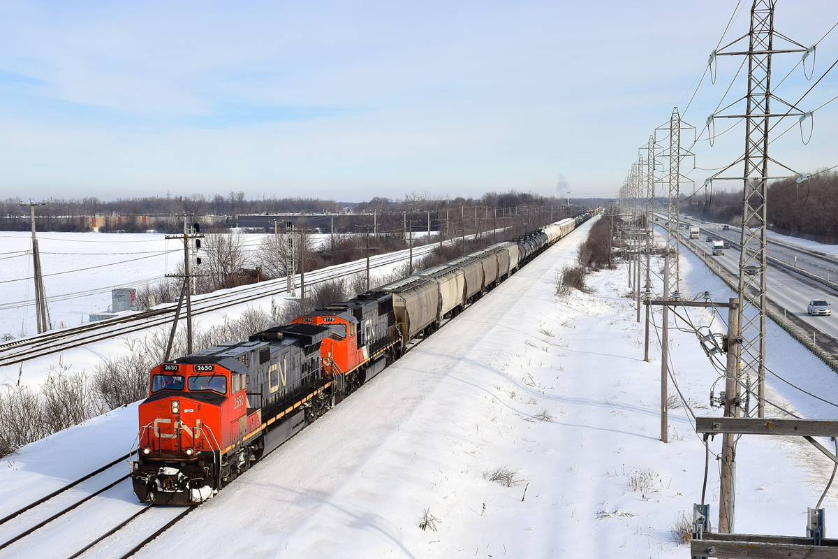 CN 2650 & CN 5779 lead a 98-car CN X371 through Sainte-Anne-de-Bellevue.