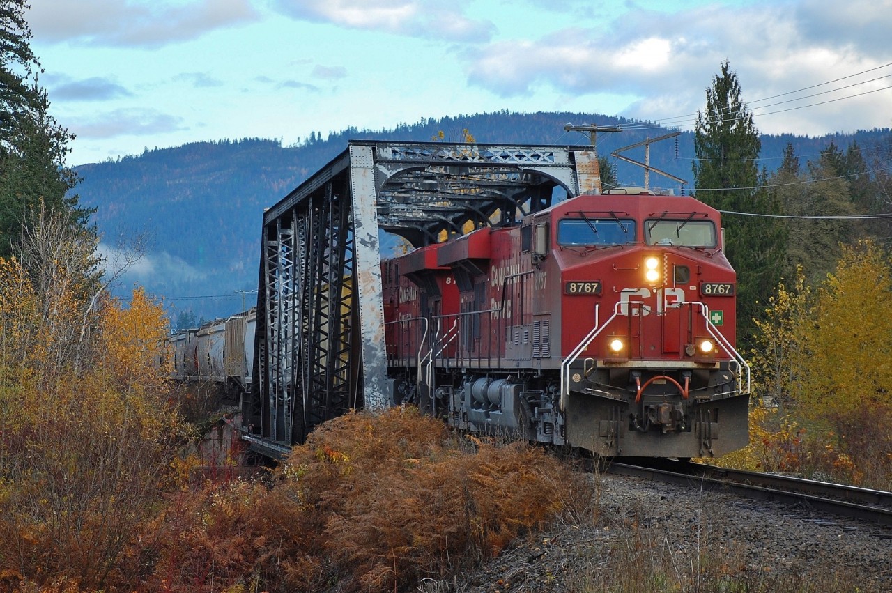 This truss style bridge is common on the Shuswap sub. This shot shows CP 8767 crossing the Eagle River in Sicamous at the head of a westbound load of grain.