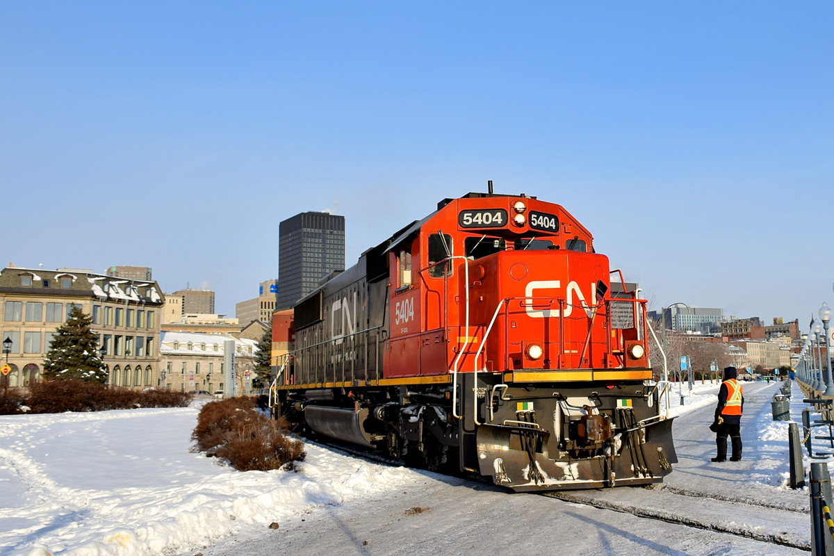 A Port of Montreal employee is flagging the last crossing as CN 149 passes with ex-Oakway SD60 CN 5404 leading a truly frigid morning.