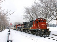 CN 149 is leaving the Port of Montreal with a variety of GE units: C40-8 CN 2039, Dash9-44CWL BCOL 4642 & Dash8-40CM CN 2420. Behind the power is 12,200 feet of platforms.
