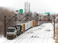 A later than usual CN 528 snakes out of Taschereau Yard as it crosses over from the north track of CN's Montreal Sub to the south track. Power is NS 2738 & NS 8947.
