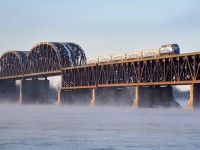 <b>As cold as it looks.</b> It's about half an hour after sunrise and a frigid -15 celsius (5 fahrenheit) as AMT 76 makes its way across the St. Lawrence River towards Montreal with ex-GO Transit F59PH AMT 1343 for power. 