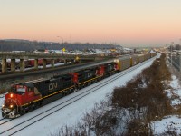 A trio of Dash9's leads CN 401 westwards on the Montreal Sub a few minutes after sunset.