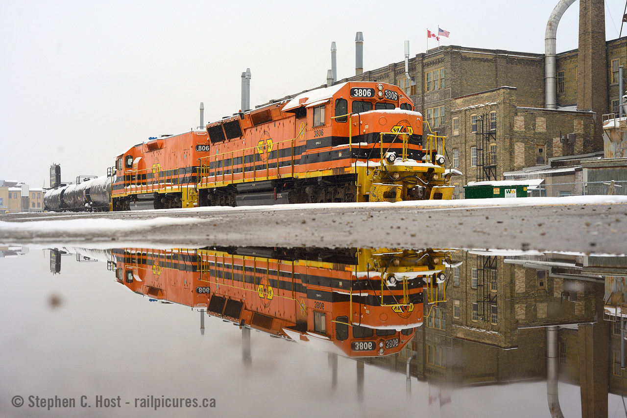 For generations there has been two constants at the Kitchener Station - the Krug furniture factory and a railway. The motive power continues to change, witness this reflection of SLA 3806 in nice, flared GP40X body with a matching paint calf 806. US and Canadian flags flapping in the background in a factory under significant pressure to turn into Condos, especially once the LRT Is up and running a block away. And snake, no, I did not use a case of water to create this pond :)