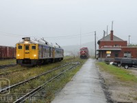 A miserable and wet morning in White River, Ontario finds Ontario's Budd's departing for Sudbury. RDC4 6250 and RDC-2 6215 are assigned the honours for the trip to Sudbury, while in the background train 112-18 sits staged awaiting a crew to come available to take the train east. <br>During this time CP crews based out of Chapleau operated the passenger between White River and Sudbury. A couple years later VIA crews would take over the run to operate the train from the CP crews. 