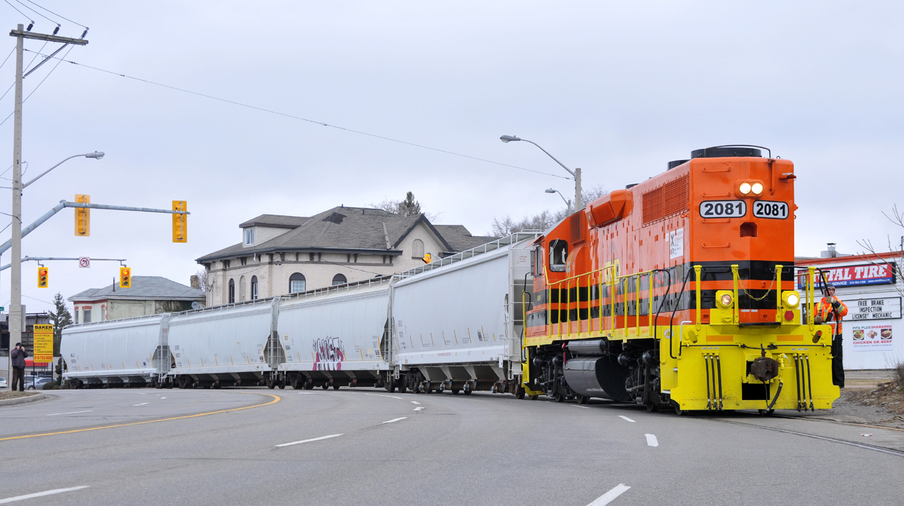The Ingenia Cannonball making the weekly trek through Downtown Brantford with RLHH 2081, and four hoppers