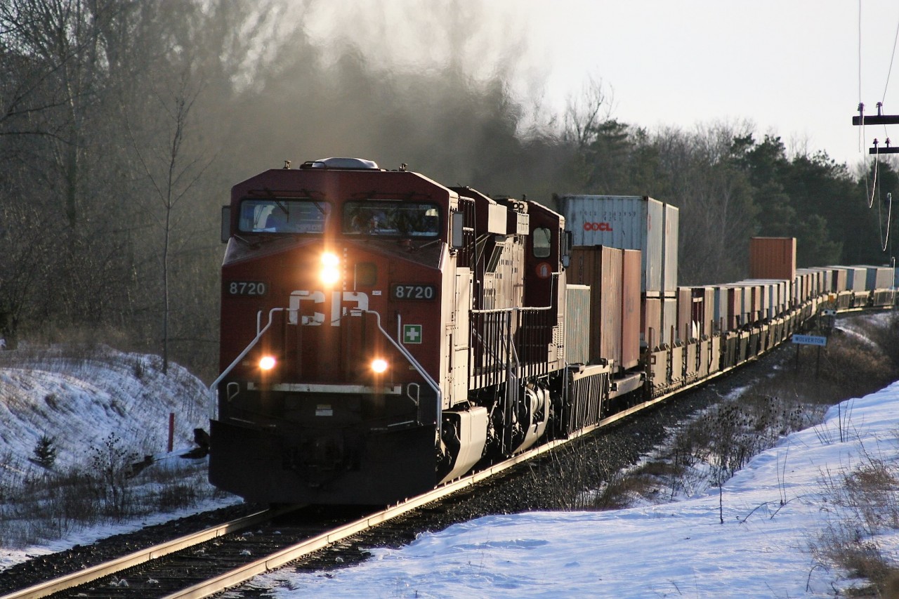 CP 8720 is seen passing the Wolverton mile board as it heads east through Ayr, Ontario in February 2007. Prior to the eastbound container train's arrival, CP 4656 west and it's short train had cleared in the back track at Ayr and would eventually back down the Ayr Pit Spur to service customers.