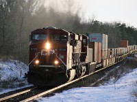 CP 8720 is seen passing the Wolverton mile board as it heads east through Ayr, Ontario in February 2007. Prior to the eastbound container train's arrival, CP 4656 west and it's short train had cleared in the back track at Ayr and would eventually back down the Ayr Pit Spur to service customers. 