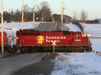 During a late February afternoon, the Hamilton Turn is seen switching over Greenfield Road in Ayr, Ontario with GP40-2 4656 and GP9u 8234. 
