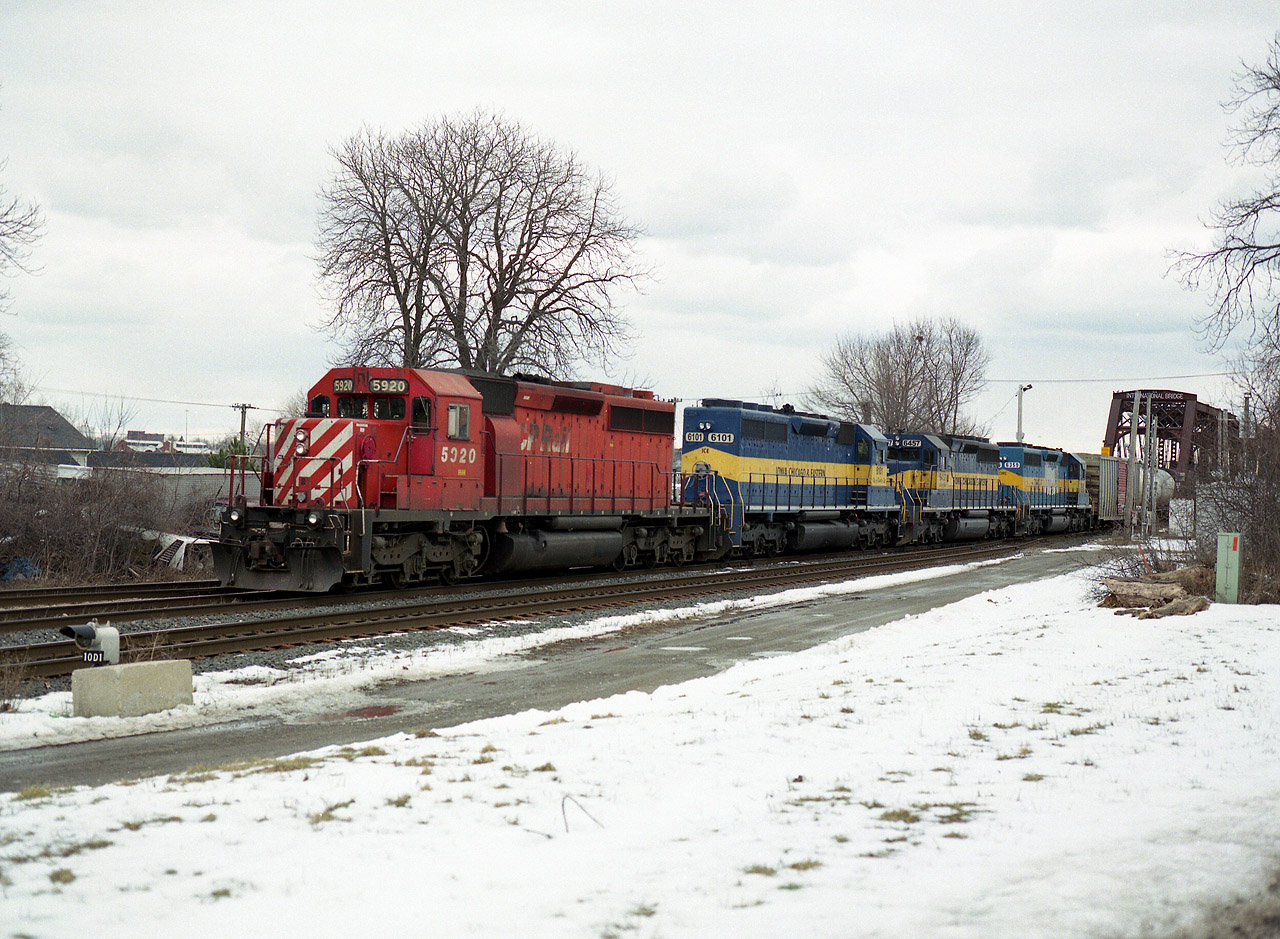 Actually to me this scene does not seem like four years ago already, but the power lashup seems like light years ago. We see nothing like this any more. Ethanol empties coming back to Canada and heading westward with CP 5920 ICE 6101, 6457 and DME 6359, she with the faded Mt. Rushmore decal on the flanks. Not many of these 'tank trains' any more, and what we see is usually  photographically uninspiring.