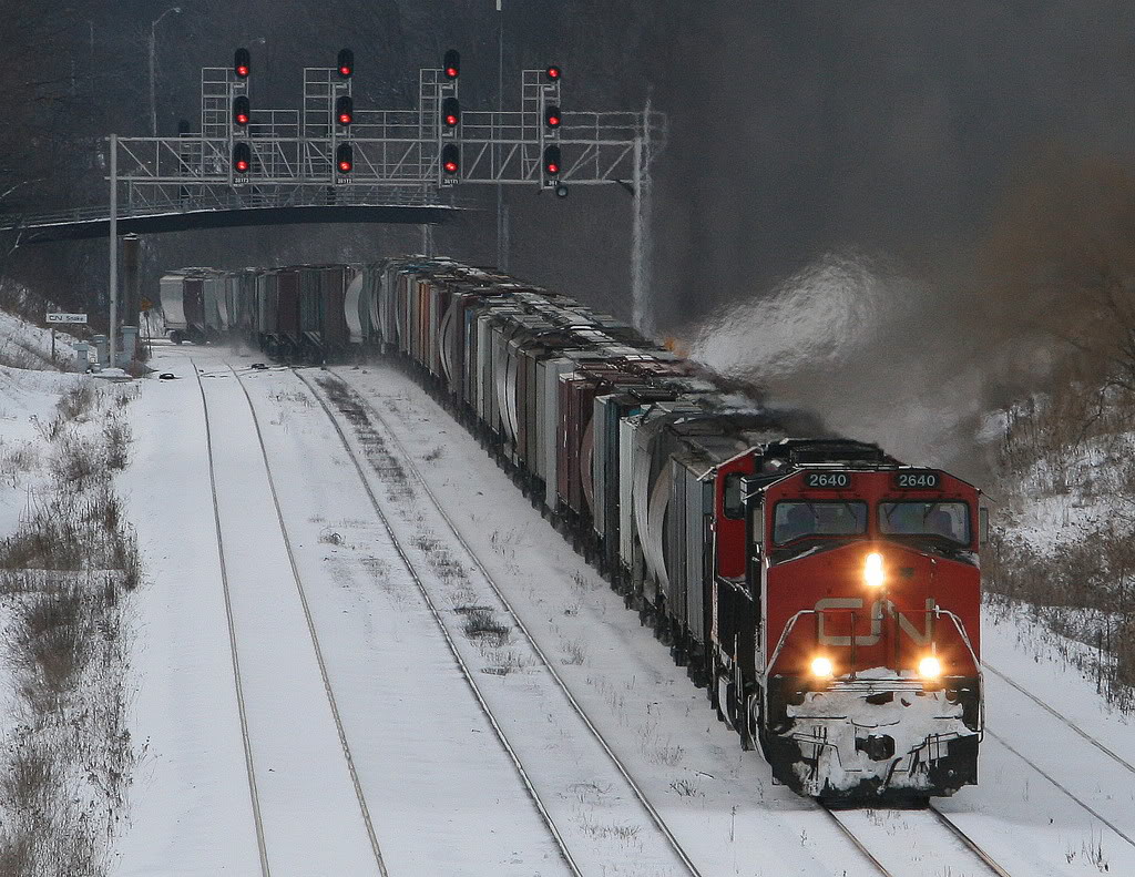 It's getting to the end of a cold Sunday -  early in January 2009...the stock market was plunging, trains were getting shorter...and in a few days, Sully would make his miracle landing.

A small rerouted G872 grain train switches from track 2 to 1 at Snake  - and heads east.