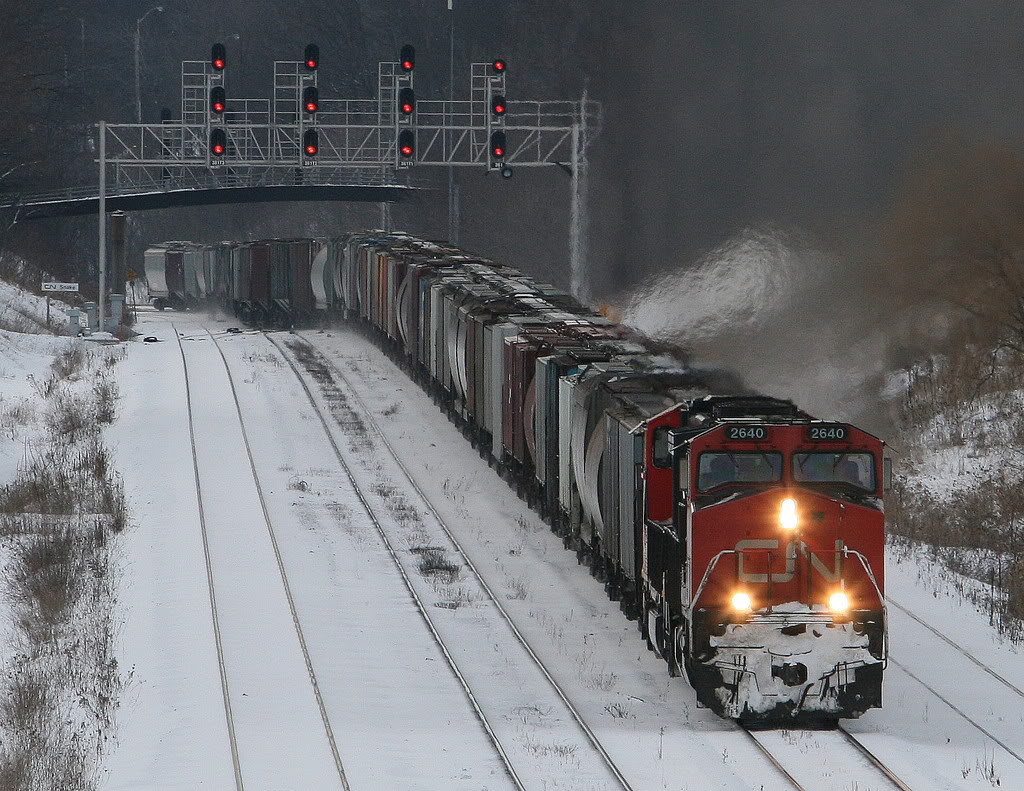 It's getting to the end of a cold Sunday -  early in January 2009...the stock market was plunging, trains were getting shorter...and in a few days, Sully would make his miracle landing.

A small rerouted G872 grain train switches from track 2 to 1 at Snake  - and heads east.
