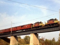 Operating on an Upper Canada Railway Society Fan trip, Grand River Railway electric freight motor 228 and Lake Erie & Northern Railway 337, the last electrics, cross the LE&N bridge over the CASO (NYC) at Waterford on September 30th, 1961. Passenger operations had already ended a few years prior in 1955, and this would be the second last day of electric operations on GRR-LE&N (electrics were used in freight service the next day). Parent Canadian Pacific's diesel locomotives would take over operations on the "CP Electric Lines" after that.