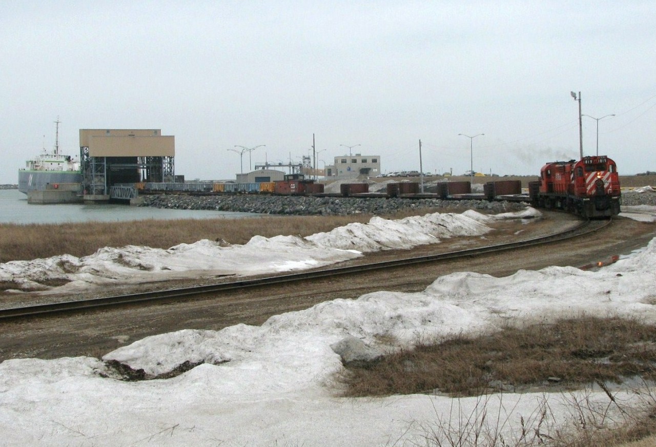 Compagnie de gestion de Matane Inc. (COGEMA) is a subsidiary of Canadian National Railway (CN)operating a dedicated railcar ferry service within Quebec between Matane and Baie-Comeau; additionally providing occasional railcar ferry service to isolated rail networks at the ports of Port Cartier, Sept-Iles and Harve-Saint-Pierre. It also operates industrial switching to rail customers in Baie-Comeau. COGEMA began operations in 1975 and operates the company's only railcar ferry, the MV Georges Alexandre Lebel (Montreal). COGEMA was sold by CN to Quebec Railway Corporation during February 1999 when QRC also purchased the Matane and Mont Joli Subdivisions. In November 2008, CN re-purchased these assets from QRC. However prior to the re-purchase, QRC 1819 and mate QRC 1851 are seen systematically unloading and reloading the Georges Alexandre Lebel railcar ferry, in preparation for its afternoon crossing of the St Lawrence River, using 5 buffer cars and customary caboose CG79507. The conductor rides in and conveniently operates from the rear of the caboose. A sister photo (id=27905) previously submitted provides a close up of this invaluable, unique marine - rail operation.