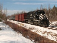 NBEC 402 rumbles through the West Collette Road crossing, enroute to Moncton, with a mixed freight and powered by the lone, black stallion NBEC 6901.   