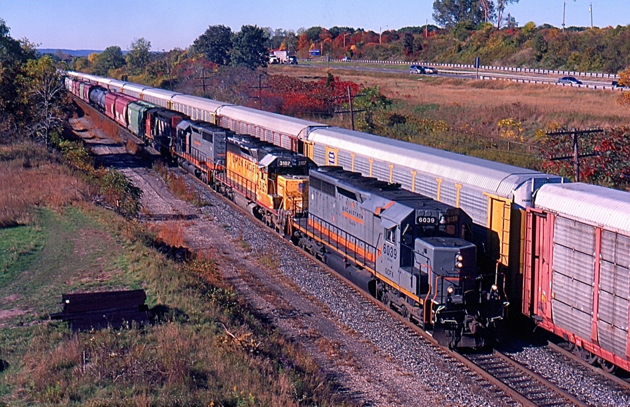 For a number of years Alstom in Montreal manufactured numerous SD40s and SD45s into what they classified as SD40-3s. In the 1990s CN sent a number of old non dash two SD40s to Alstom for remanufacturing. They later returned to CN for long term lease, the units traded their CN paint for a Coat of grey and GCFX reporting marks. Here we find CN train 398 with an all SD40 lash up including a pair of GCFX rebuilds along with a SD40 from both CN and UP. The train is just about to duck under Lemonville Road and pass Aldershot yard as it continues its journey to Toronto yard.