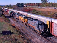 For a number of years Alstom in Montreal manufactured numerous SD40s and SD45s into what they classified as SD40-3s. In the 1990s CN sent a number of old non dash two SD40s to Alstom for remanufacturing. They later returned to CN for long term lease, the units traded their CN paint for a Coat of grey and GCFX reporting marks. Here we find CN train 398 with an all SD40 lash up including a pair of GCFX rebuilds along with a SD40 from both CN and UP. The train is just about to duck under Lemonville Road and pass Aldershot yard as it continues its journey to Toronto yard. 