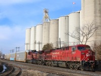 CP train 142 storms eastward past the large Ardent mill in Streetsville with repainted 9597 up front. In the foreground is the dormant ADM spur, and the train is just about to cross the Credit River.