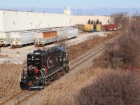 A shot I've wanted to attempt for quite some time, and with OBRY just clear of the CN diamond in Brampton I hiked my way up the side of highway 401 to wait for the twice a week train. The industry to the left is the main reason why CP has retained the trackage to this point, unfortunately the warehouse to the right appears to be not receiving rail service anymore. This day the OBRY was unfortunately running as light power to Streetsville, and is seen entering trackage rights over CP to Streetsville Junction. 