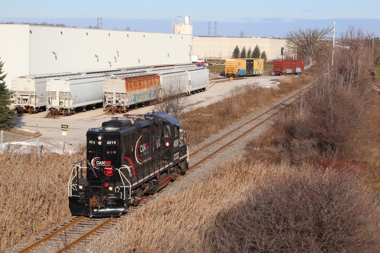A shot I've wanted to attempt for quite some time, and with OBRY just clear of the CN diamond in Brampton I hiked my way up the side of highway 401 to wait for the twice a week train. The industry to the left is the main reason why CP has retained the trackage to this point, unfortunately the warehouse to the right appears to be not receiving rail service anymore. This day the OBRY was unfortunately running as light power to Streetsville, and is seen entering trackage rights over CP to Streetsville Junction.