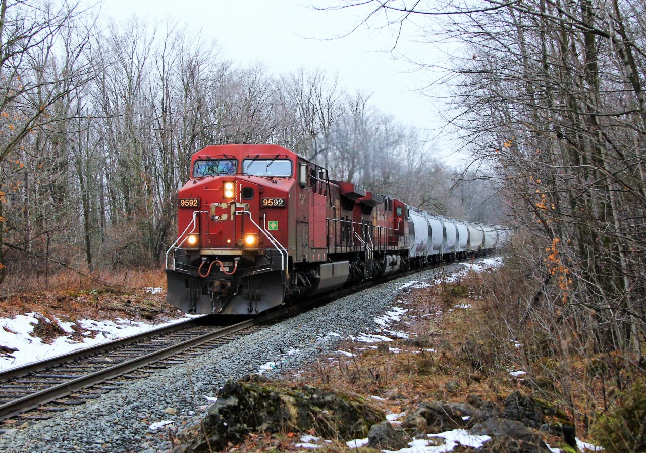 Todays CP 646 train led by CP 9592 with CP 9724 had its tankers sandwiched in between hopper cars on the lead with auto racks trailing as it heads through the bush and rocks on its way to Hamilton