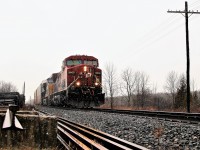 Through a light snow and drizzle, CP 9600 with CSX 3418 accelerate past MM 52 and Side road 10 on their way to Guelph Junction.