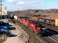For me, this is how I remember Aldershot the best. On any day trains from CN,CP,VIA,GO Transit and Amtrak could be found rolling past the landmark, old but still used cold storage building, and there always seemed to be a train busy working in the yard. Sadly the installation of the third track would not only bring the demise of the cold storage building but also the installation of fencing along the mainline. Time marches on I guess. Here we have a CP trackage rights train headed to the CP connection at Campa Jct. passing CN local 552 busy switching the yard.