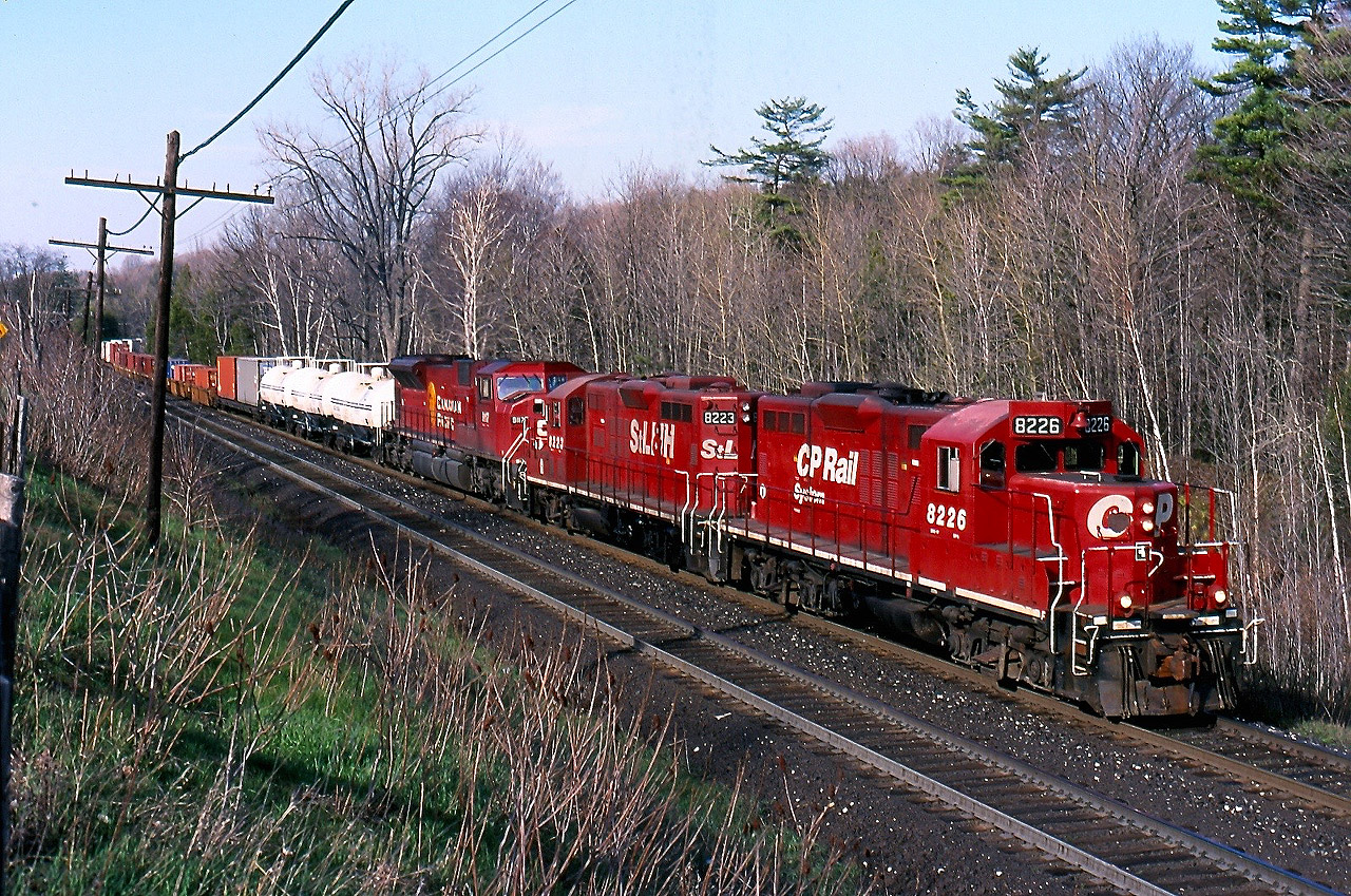 Trains stalling on the grade up the Niagara Escarpment through Campbellville was certainly not uncommon not all that long ago. Train 153 was a hot intermodal train and often was assigned a single unit for its trip to Chicago. Many single unit trains over the years sucumbed to the grade much as 153 did this day. Luckily the "Ham turn" was in the area and it's pair of veteran "Geeps" came to the rescue assisting the SD90 and its train up the hill. Hard to believe that today the GP9s are all gone and the SD90s may never come out of storage again.