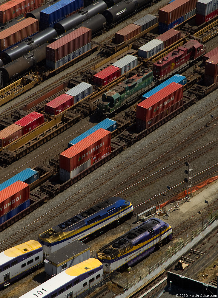 Two Canadian Pacific locomotives and two West Coast Express trains rest in Vancouver on a warm July day.