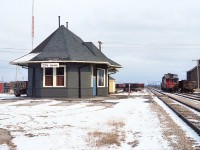The old CN Jarvis station has been in the news as of late. It was purchased and moved across Hwy 3 on October 18, 2016 to a new location at Walpole Antique Farm Machinery site at 3018 Hwy 6, Jarvis, just south of the Intersection of Hwys 3 & 6 in town. This building sat empty for a few years after failed efforts to use it for commercial purposes. Now, with the station out of the way, the land is going to be the home of....what else? Another Tim Hortons!!
This view taken in better days shows the scene looking east. CN 4509 and van 79683 awaits new business over by the long demolished Jarvis Freight Shed. Thats the "sidekick" wandering along the backtrack.(She shows up everywhere...checking to see if I was pursuing steel wheeled beauties rather than the two legged ones, I guess). That is the old CN Hagersville line in the background, now leased to SOR (RLHH). Otherwise most everything in this 37 year old view is gone today. A "Time Machine" shot would feature a closeup of a Timmys. Good Grief !!