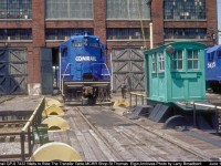 Conrail GP-9 7432 waits outsde the MCRR Shop St Thomas for Labourer Gerry MacCaffery to to reposition it into another Bay to be lifted for a Traction Motor change out. 