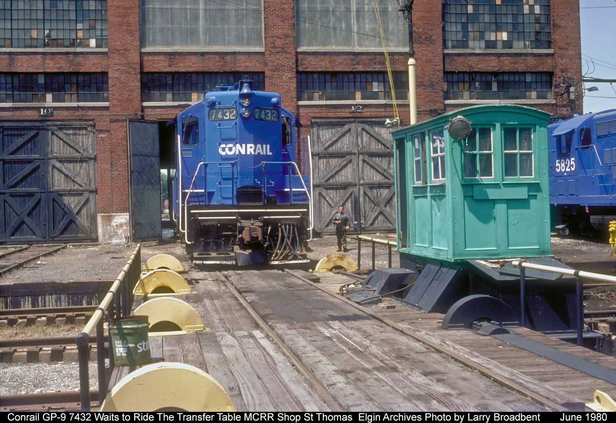 Conrail GP-9 7432 waits outsde the MCRR Shop St Thomas for Labourer Gerry MacCaffery to to reposition it into another Bay to be lifted for a Traction Motor change out.