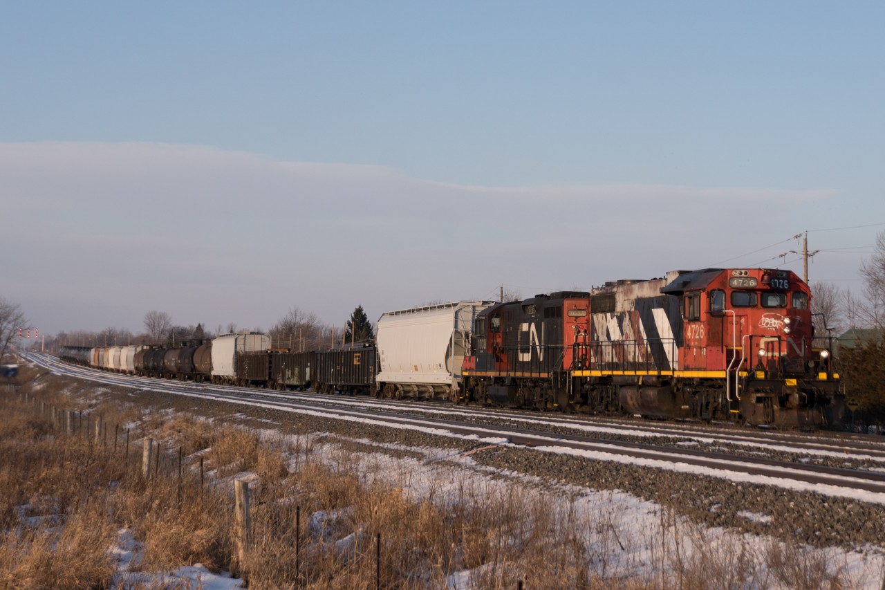 Heading east for a full day's work, 4726 and 7038 scream their lungs out as CN 518 gets up to speed out of Belleville.