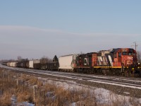 Heading east for a full day's work, 4726 and 7038 scream their lungs out as CN 518 gets up to speed out of Belleville.