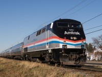 It looks unseasonably comfortable for a late November morning as Amtrak's Adirondack passes through Saint-Hubert, an area previously served by the Montreal and Southern Counties. Less than 10 miles into its 381 mile journey for the day, the train will travel about another 10 hours to New York City, including the time taken to trade the Phase III heritage unit for a dual-mode locomotive at Albany-Rensselaer.