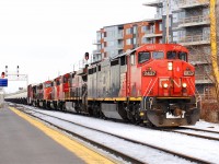 CN-2437 a Ge-C-40-8m leading loco of 5 locos pulling a long convoy on route CN-401 going to Taschereau yard near Dorval no stopping in Southwark yard the yard full of covered Hopper cars and others  so was going none stop to Taschereau yard 