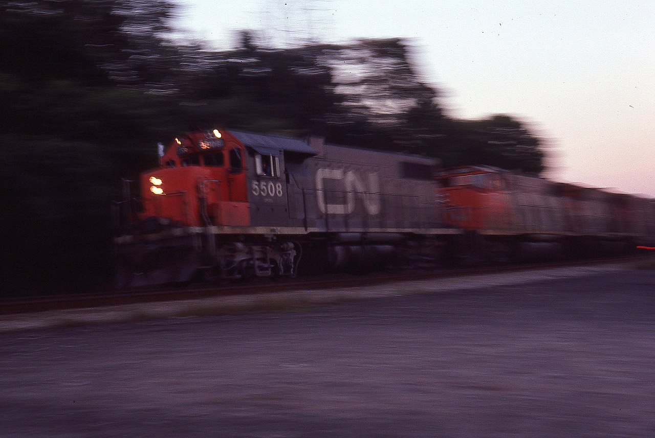 I have long forgotten, but no doubt this was one of those times when the "gang of us" spent the whole day yakking and kabbitzin' at the junction; talking trains and taking pictures as well. I am guessing I probably stated I was not going home until I saw "one more train" for whatever reason. But the sun went down first. Along comes that train, and well, I am there.....so not to waste an opportunity I probably set the camera at about 15h of a sec and tried to pan this thing as it went off the Oakville onto the Dundas. Interesting, anyway. I like it.  Numbers not recorded.