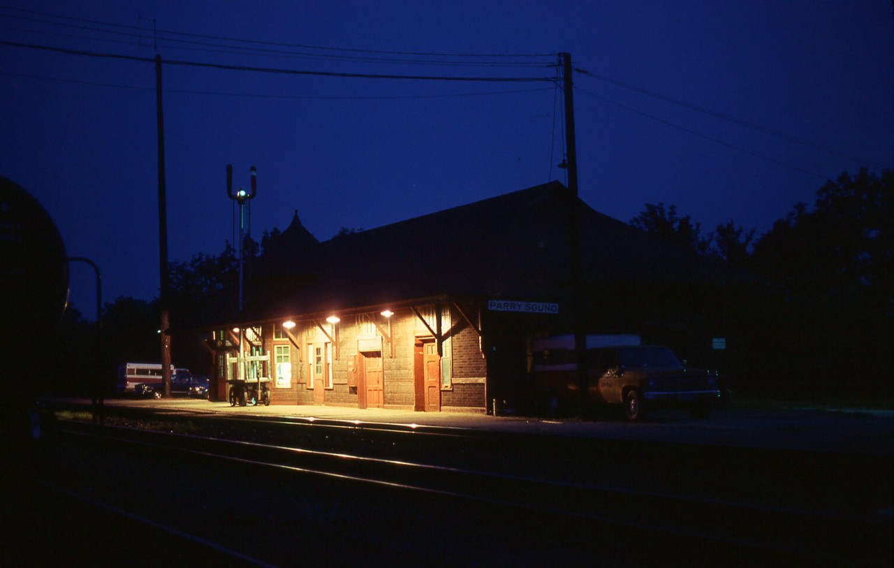 Nice warm early summer night in Parry Sound. I had been sitting in the station yakking it up with the agent/operator (Jimmie Bell) and decided I would wander out for a night shot of the building. Something I had not yet done there. I was greeted with smirks when I got back into the safety of that station. Only an out of towner would be dumb enough to take on combat with the voracious mosquitoes. Yeah, I lost. It was a long day out there taking pictures because the southbound Canadian was very late; showing up somewhere around 11PM. Normally it was early evening back then.