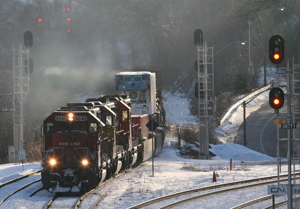Answering to Sir Ricky Host's call for some real winter..here we have CP 255 eastward on the Oakville Sub with two rent-a-wrecks trailing...even some ocean containers on the head end....a real bone chlling bitter cold windy day.
