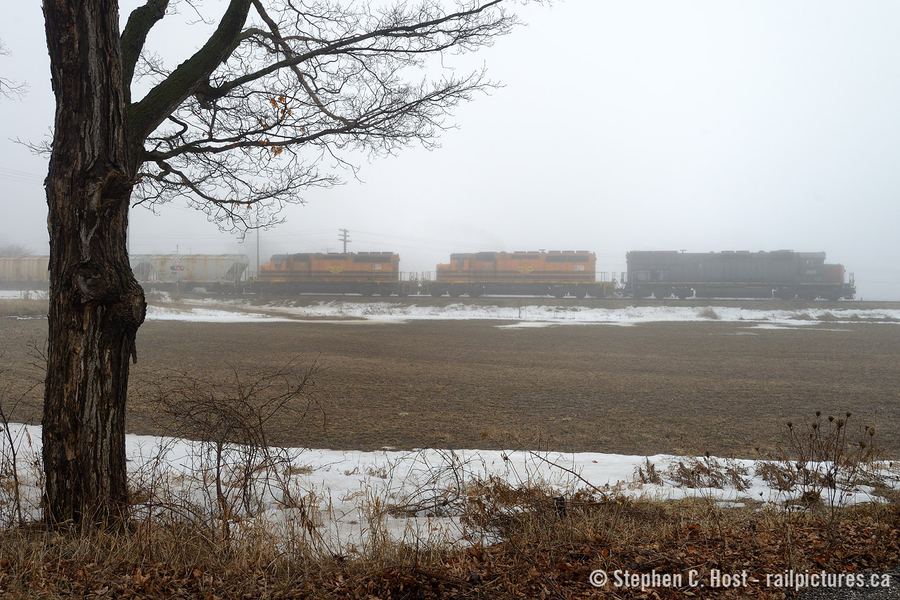 The melodic sounds of a trio of turbocharged 645's... in notch 8 with 86 cars on the drawbar , cutting through a winter fog with 86 cars on the drawbar - priceless. General Electric? What's that?