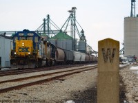 CSX Train D724 is seen working the huge (Words do not describe the size of this complex) W.G. Thompson and Sons elevator at Blenheim, Ontario on the former St. Thomas to Walkerville east/west mainline of the C&O. A nice feature of the Sarnia and Blenheim subs are concrete whistle posts and mile markers - they date to the Lake Erie and Detroit River Railway, possibly even earlier. (And of interest, the LE&DRR Still owns the land and leases the rest of the line to CSX to this day). D724 was a Chatham -> Blenheim -> Sarnia turn two days a week (Tues/Thurs) and a Sarnia -> Sombra turn Mon/Wed/Fri.  D724 still runs occasionally to Sombra, but Blenheim track is now under CN ownership with sporadic service at best from CN 511 based in Chatham. <br><br>And in the usual custom, I'd like to take you into the Wallaceburg RTC office with a track release as D724, Southbound for Blenheim, releases Chatham yard limits to the RTC and is given the OK to enter rule 105 at Blenheim 8 miles south.<a href=http://steve.hostovsky.com/2613_blenheim.mp3>Click here - 750kb mp3</a>