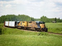 ONR 1733 and 1734 head southward on a beautiful June afternoon. That old shack in the field probably is all there is left of South Mindoka. The sawmill town died in the 1940s and was abandoned by 1960. Another ghost town of the North. Only a mile up the line from here was the community of Mindoka itself, still a namesign on the ONR. It once had bunks for the T&NO employees as well as the Temiskaming & North Ontario railroad station. It too, vanished.