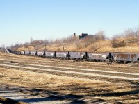 The main reason I am posting this shot is for Historical Purposes, as there are a number of TH&B devotees on this site. So where did all that old TH&B rolling stock go? Here is a long string of cars no doubt heading for the scrapper. Perhaps to the United States. I never did find out. RIP.