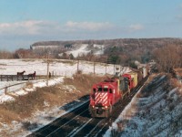 Canadian Pacific's first SD40 #5500 leads a short train through Campbellville. This was taken from the wooden bridge overpass connecting two sections of farmland with permission from the landowner. In the top left is the ski hills of Kelso.